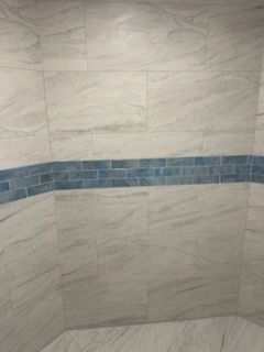 A white truck is parked next to a wooden ramp leading to a house.