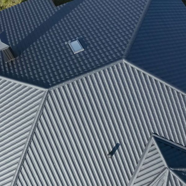 An aerial view of a gray metal roof with a skylight.