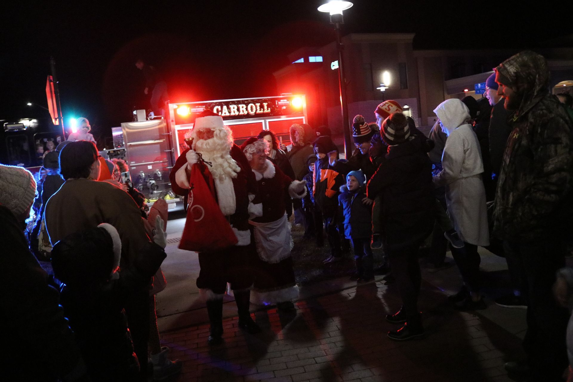A group of people are standing in front of a fire truck.