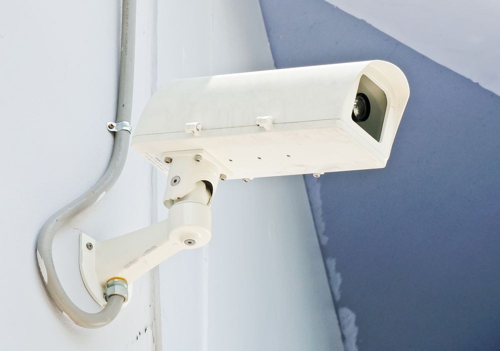 Contemporary white CCTV system mounted on the wall for reliable security — Alarm Monitoring in Bowral, NSW