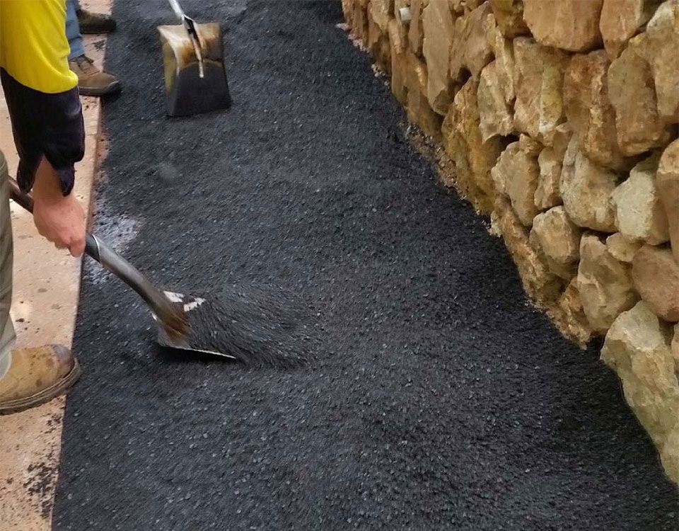 Asphalt Spreading To Fill In A Trench Patch — Bitumen Services in Darwin, NT