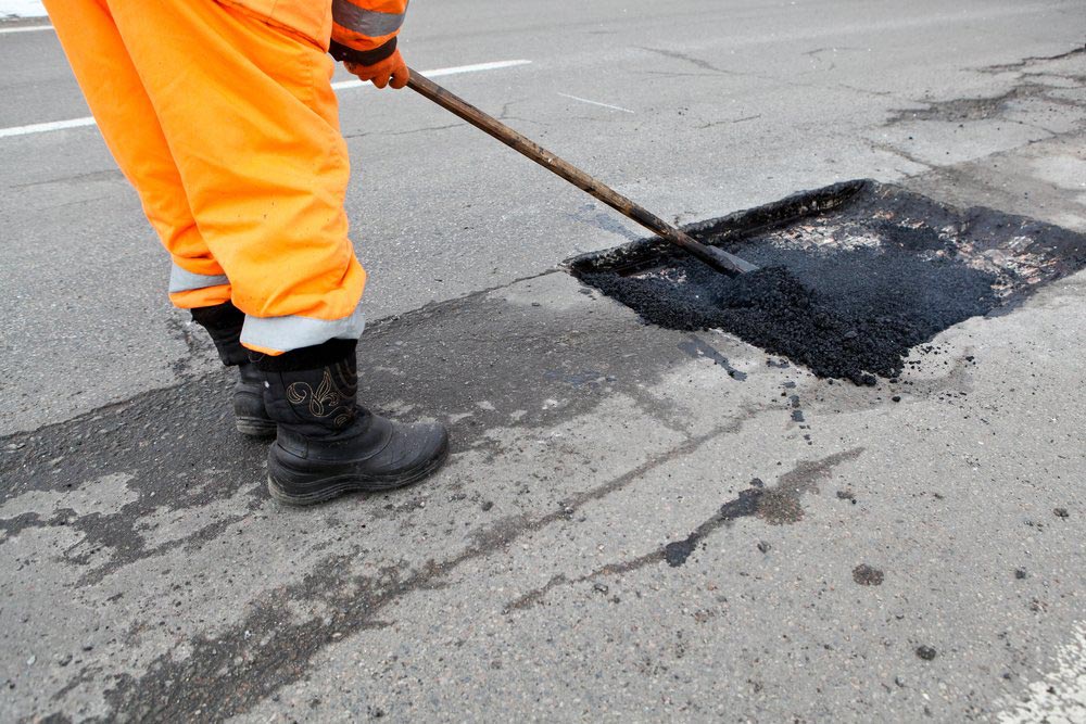 Putting Asphalt On Damaged Road — Bitumen Services in Darwin, NT