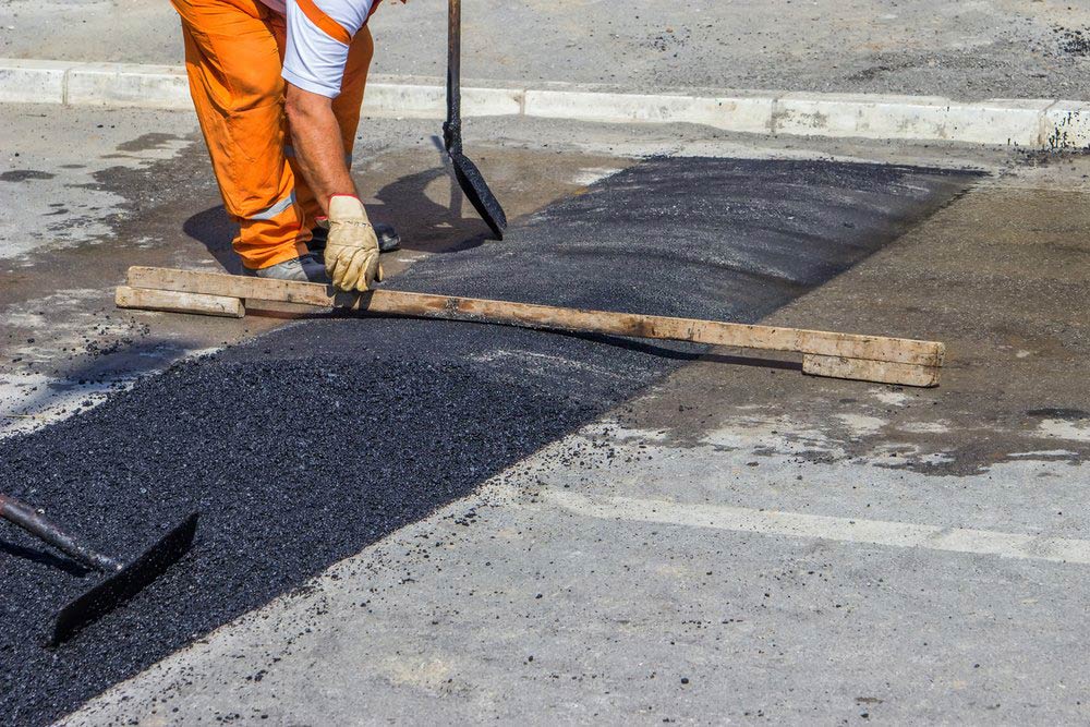 Worker Installing A New Speed Hump — Bitumen Services in Darwin, NT