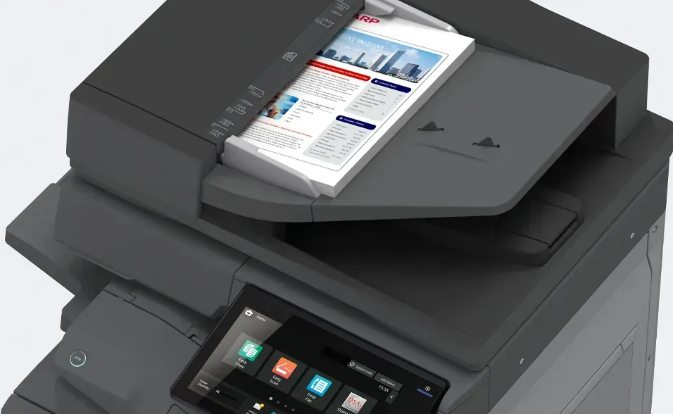 Multifunction printer, black, with a color document in the document feeder. Touchscreen control panel visible.
