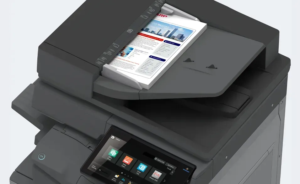 Multifunction printer, black, with a color document in the document feeder. Touchscreen control panel visible.