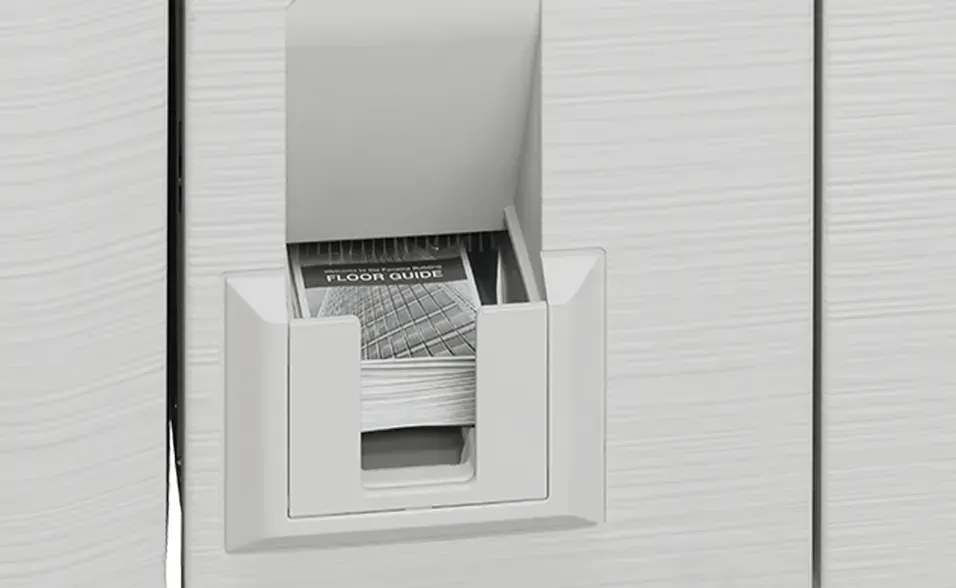 A white card rack built into a wall, filled with brochures.
