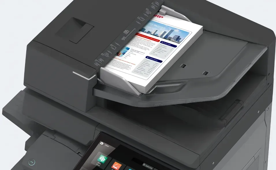 Multifunction printer, black, with a color document in the document feeder. Touchscreen control panel visible.