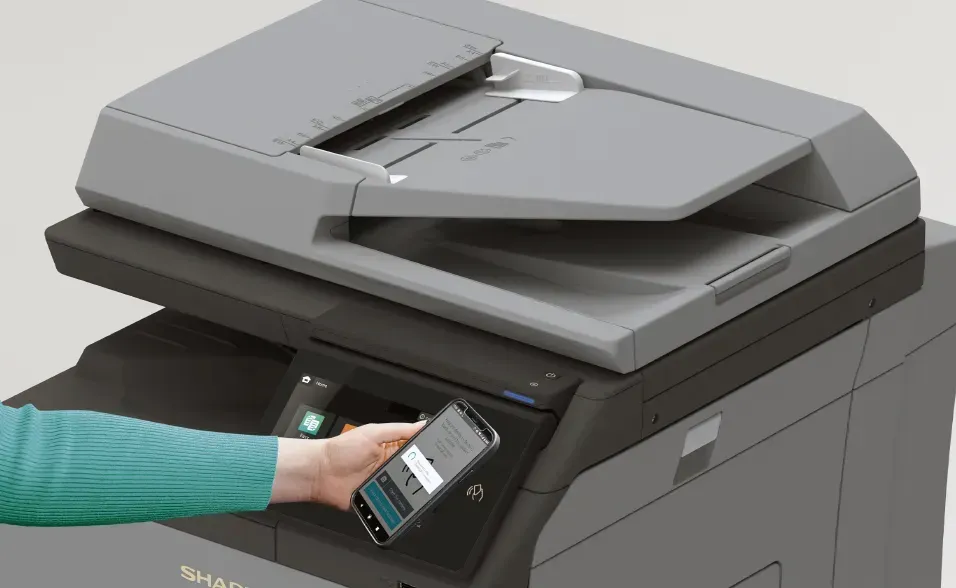 Hand using phone to access printer.