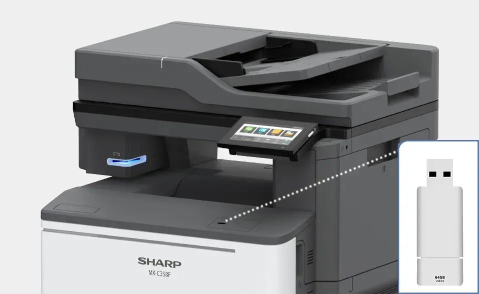 A Sharp multifunction printer with a USB flash drive connected.