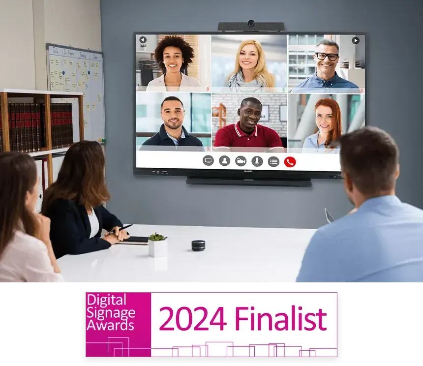 People in a meeting room watching a video conference on a large display, with Digital Signage Awards 2024 Finalist logo.