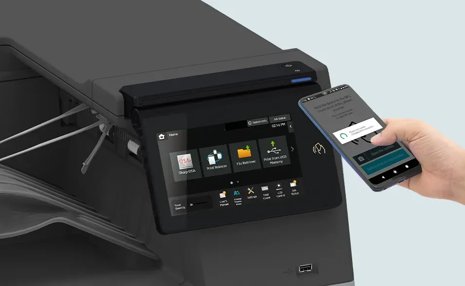 A hand holds a smartphone near a printer's touchscreen. The screen displays icons, suggesting print options.