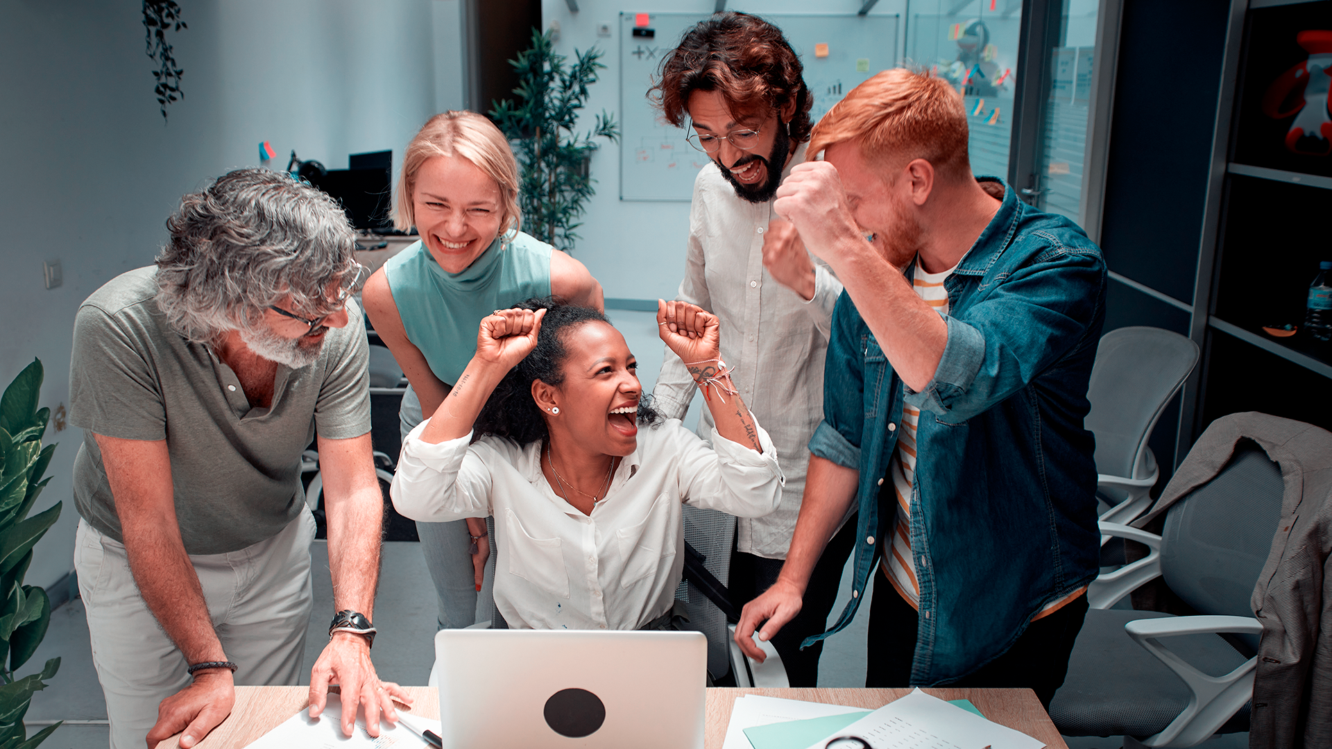 Imagem com uma equipe trabalhando feliz em conjunto.