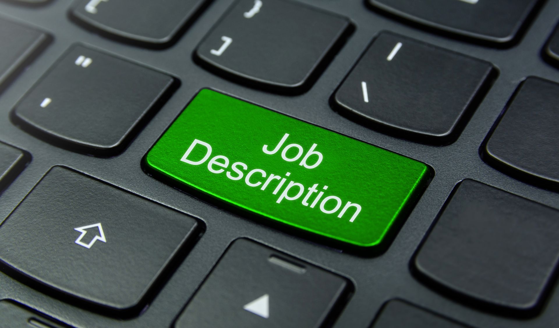 Imagem de um teclado com uma tecla destacada na cor verde escrito Job Description