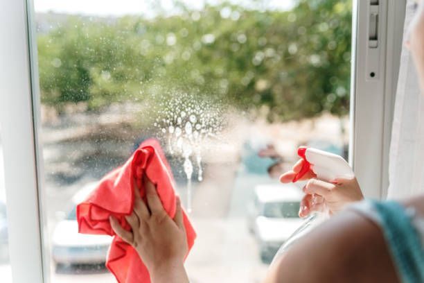 Woman's Hand Cleaning A Window — West Palm Beach, FL — Maid Golden LLC