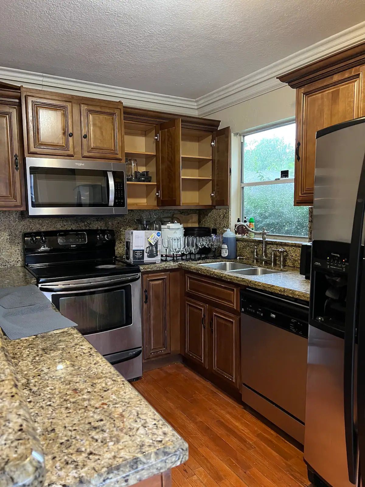 A kitchen with stainless steel appliances and granite counter tops.