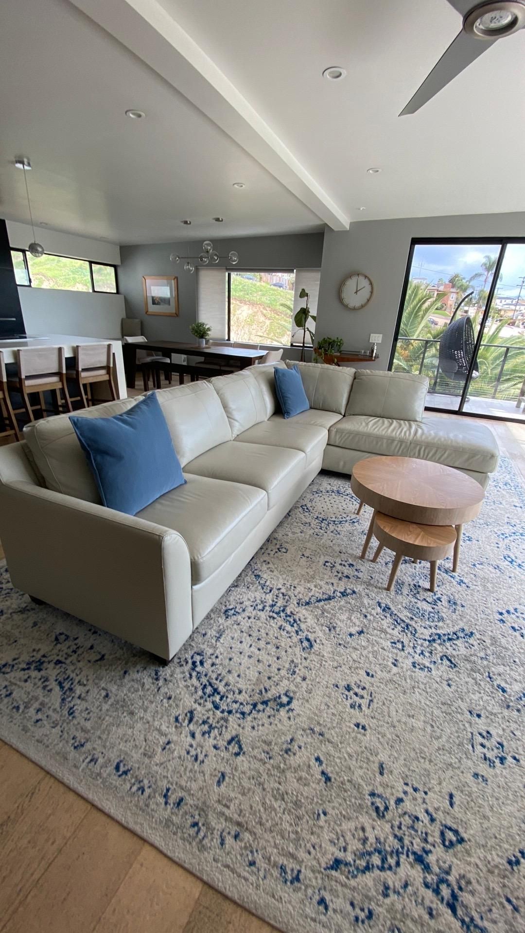 A living room with a couch , table , and rug.