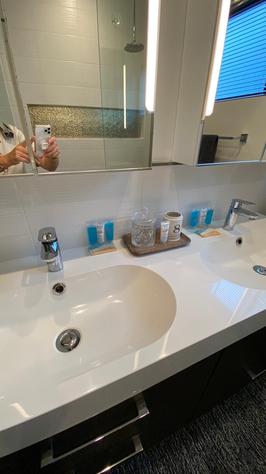A bathroom with two sinks and a mirror.