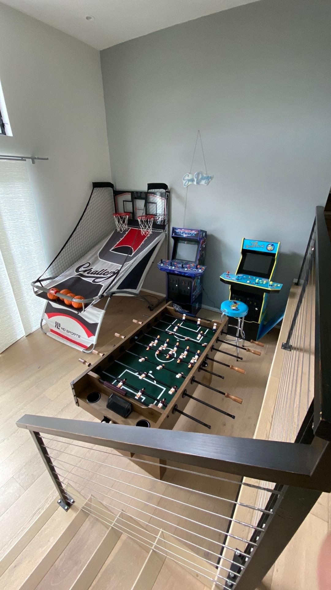 A room with a bunch of arcade games on the floor.