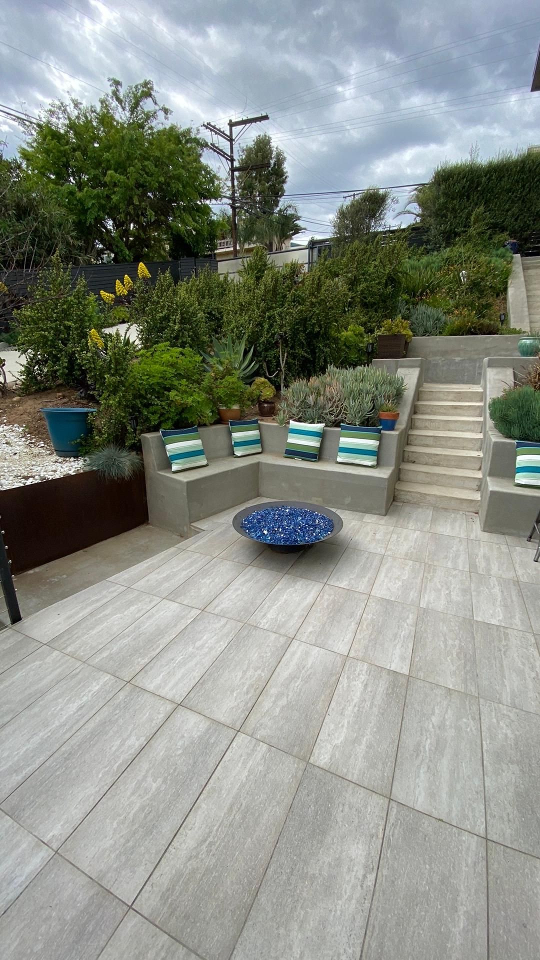 There is a fire pit in the middle of the patio.