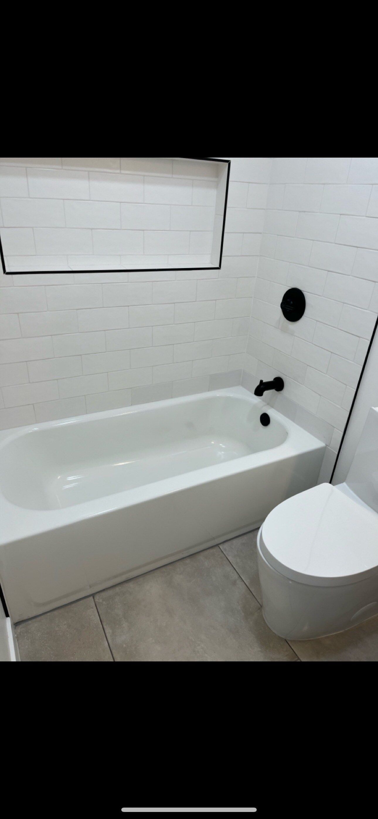 A bathroom with a bathtub and a toilet.