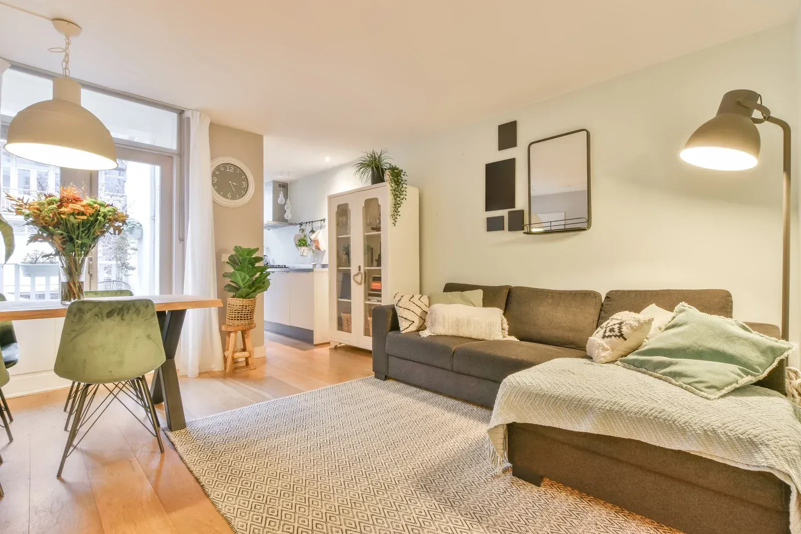 A living room with a couch , chairs , and a rug.