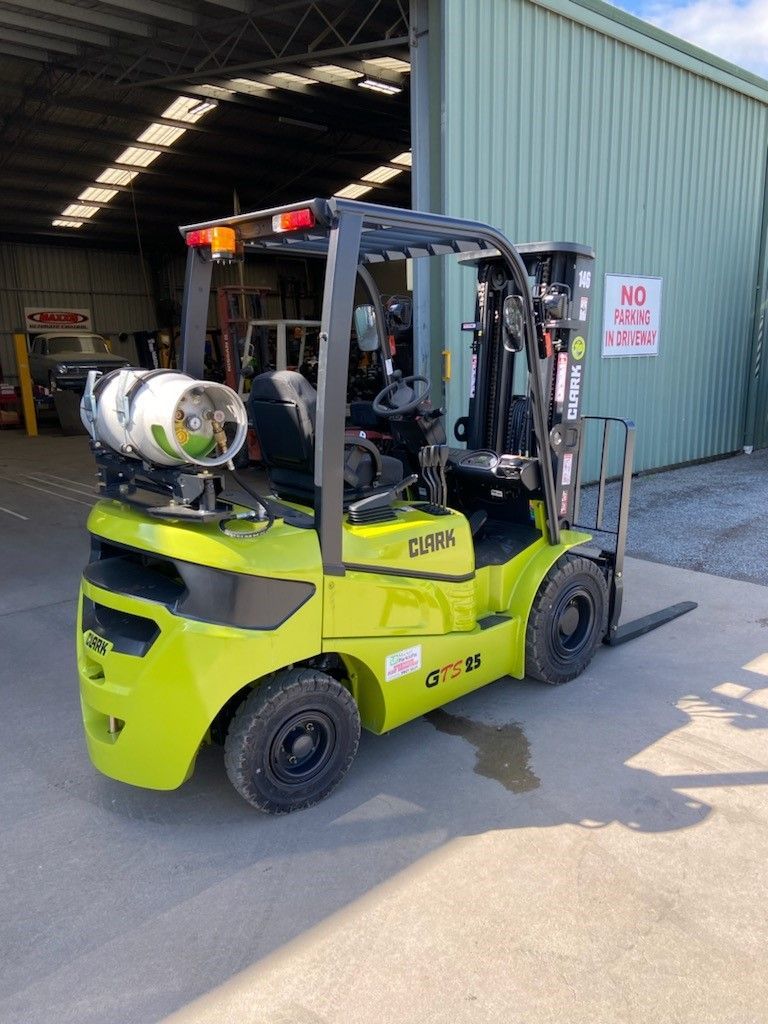 A Man Is Writing on a Clipboard in Front of a Forklift in a Garage | Shepperton, VIC | L&P Mackin Forklifts