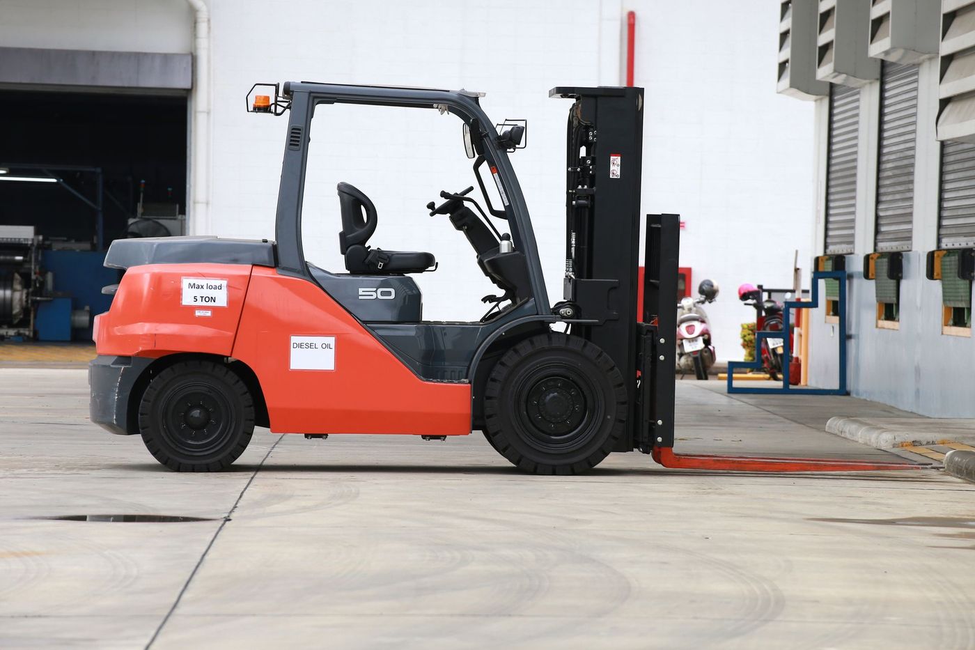 A Forklift Is Parked in a Parking Lot in Front of a Building | Shepperton, VIC | L&P Mackin Forklifts
