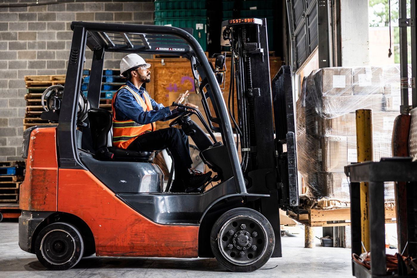 A Man Is Driving a Forklift in a Warehouse | Shepperton, VIC | L&P Mackin Forklifts