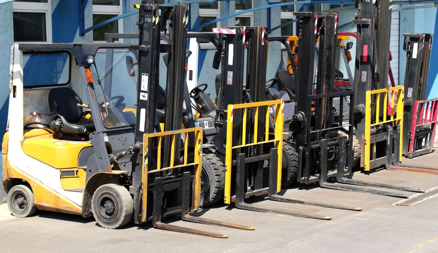 A Row of Forklifts Are Parked in a Parking Lot | Shepperton, VIC | L&P Mackin Forklifts