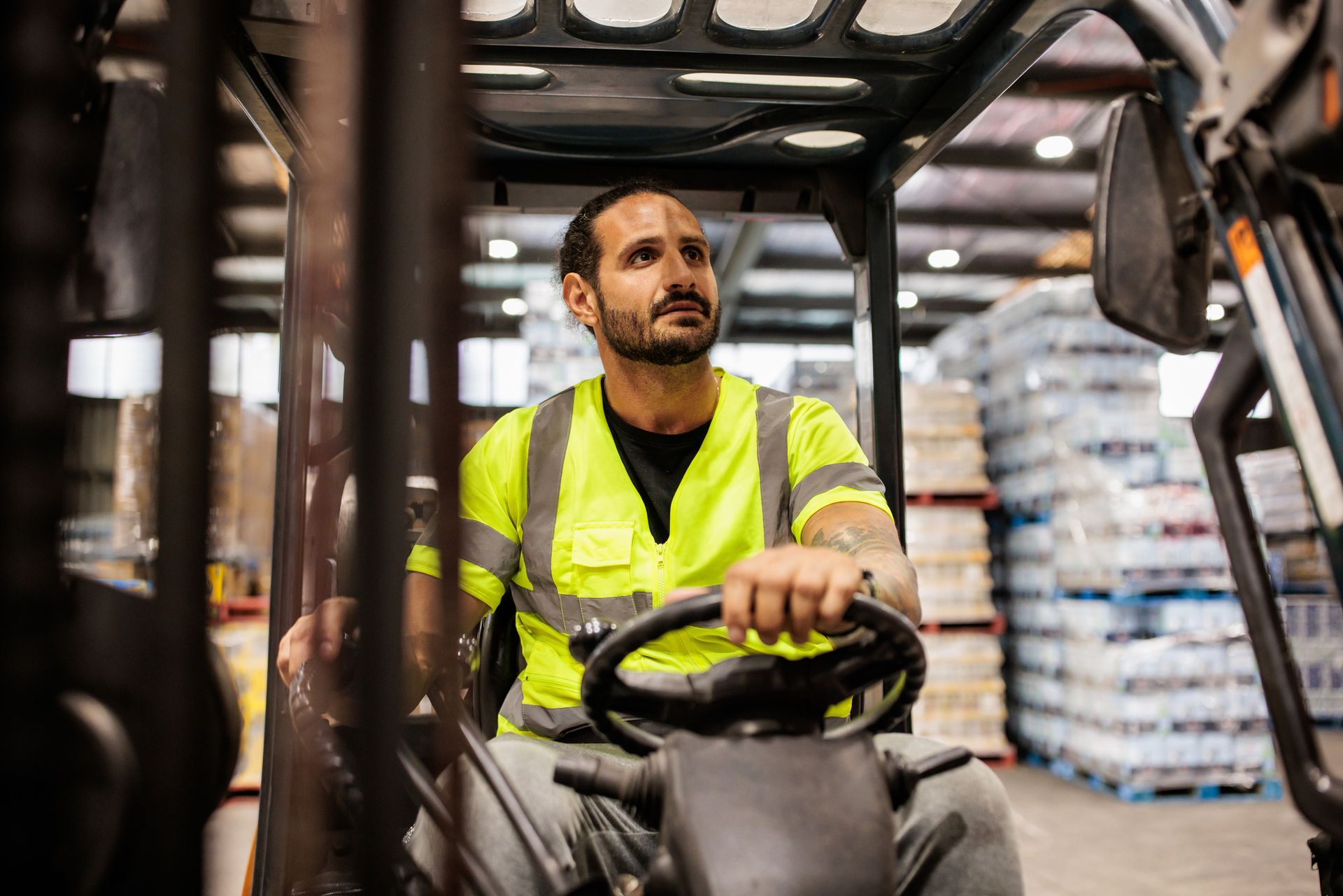 Warehouse worker operating a forklift.