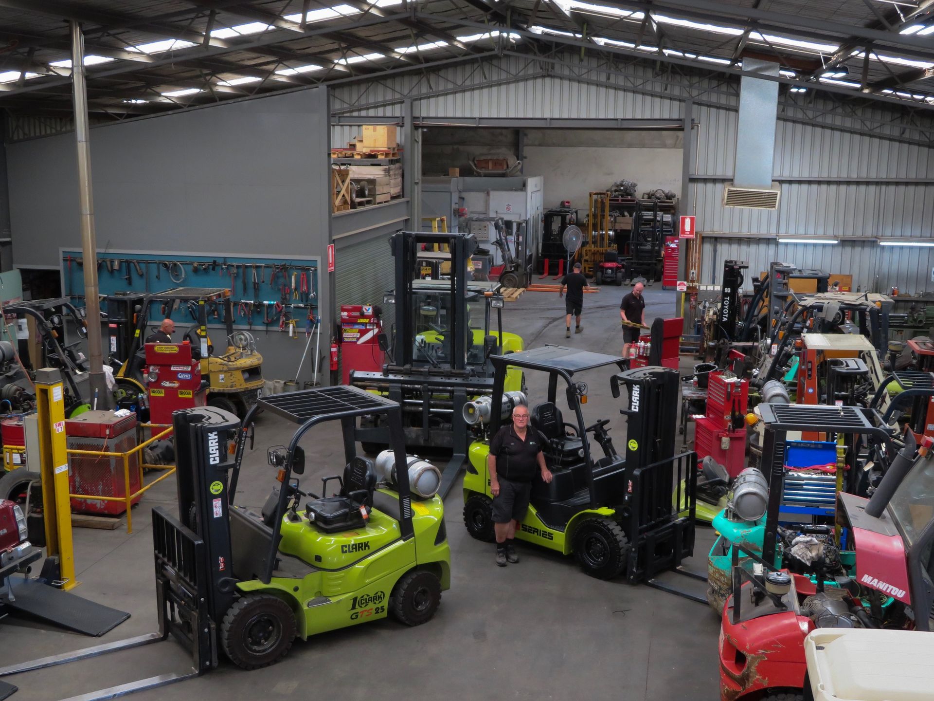 Two Men Are Standing in a Warehouse Next to a Forklift | Shepperton, VIC | L&P Mackin Forklifts