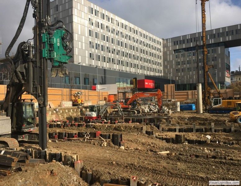 eine Baustelle mit einem großen Gebäude im Hintergrund