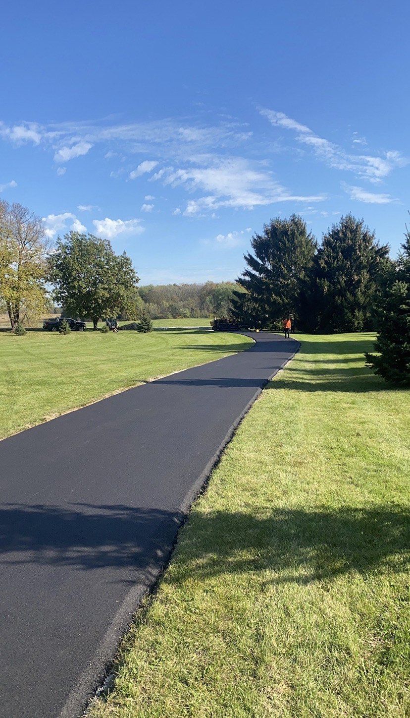 Left Turn Asphalt With Sunlight - Cottage Grove, WI - Perla Asphalt Maintenance & Sealcoating