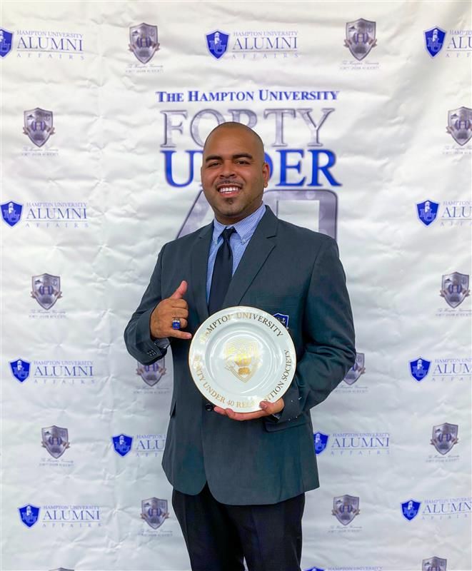 A man in a suit and tie is holding a plate.