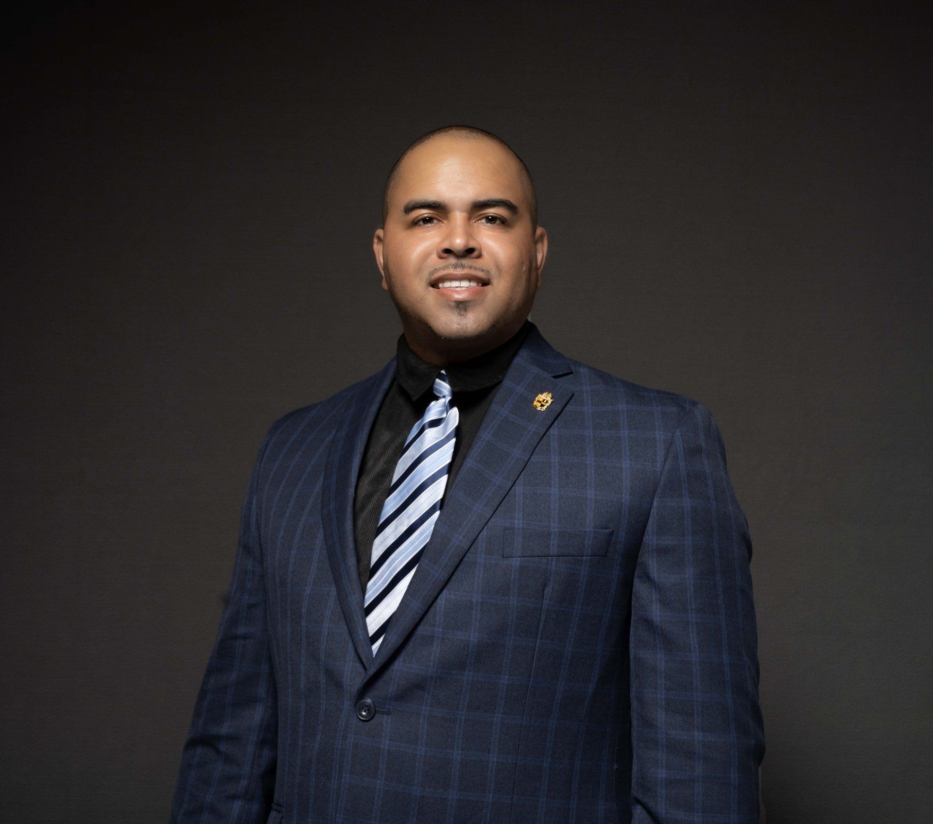 A man in a suit and tie is smiling for the camera.