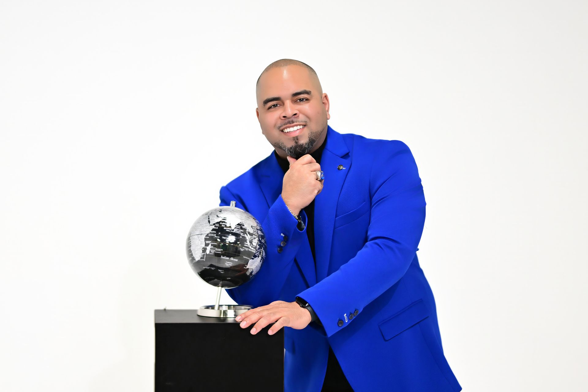 A man in a suit and tie is smiling for the camera.