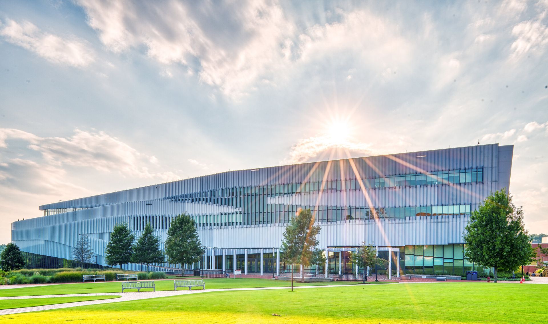 The sun is shining through the windows of a large building.