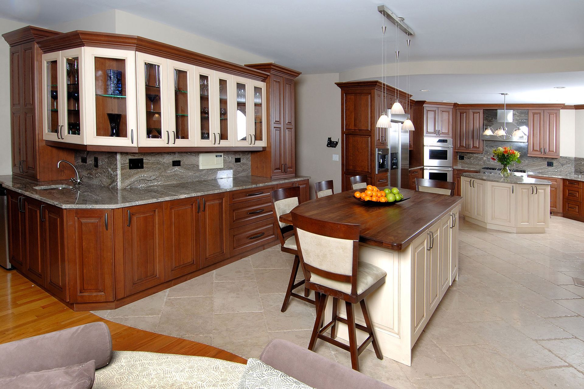 A man is standing in a kitchen working on a sink.