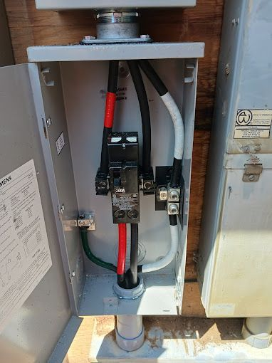 A close up of a electrical box with wires coming out of it.