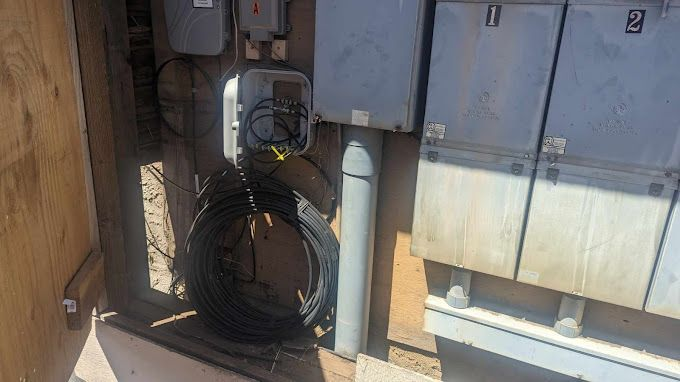 A bunch of electrical boxes are sitting next to each other in a room.