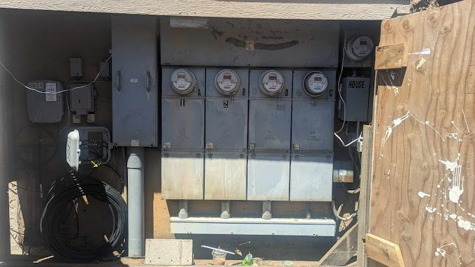 A large electrical box with a lot of electrical equipment inside of it.