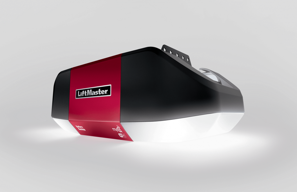 A black and red garage door opener is sitting on a white surface.