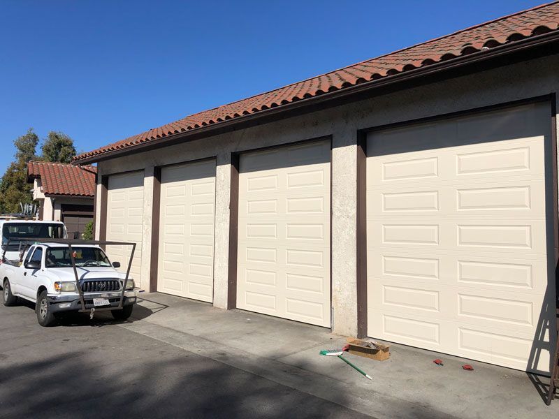 A wooden garage door with blue trim and windows