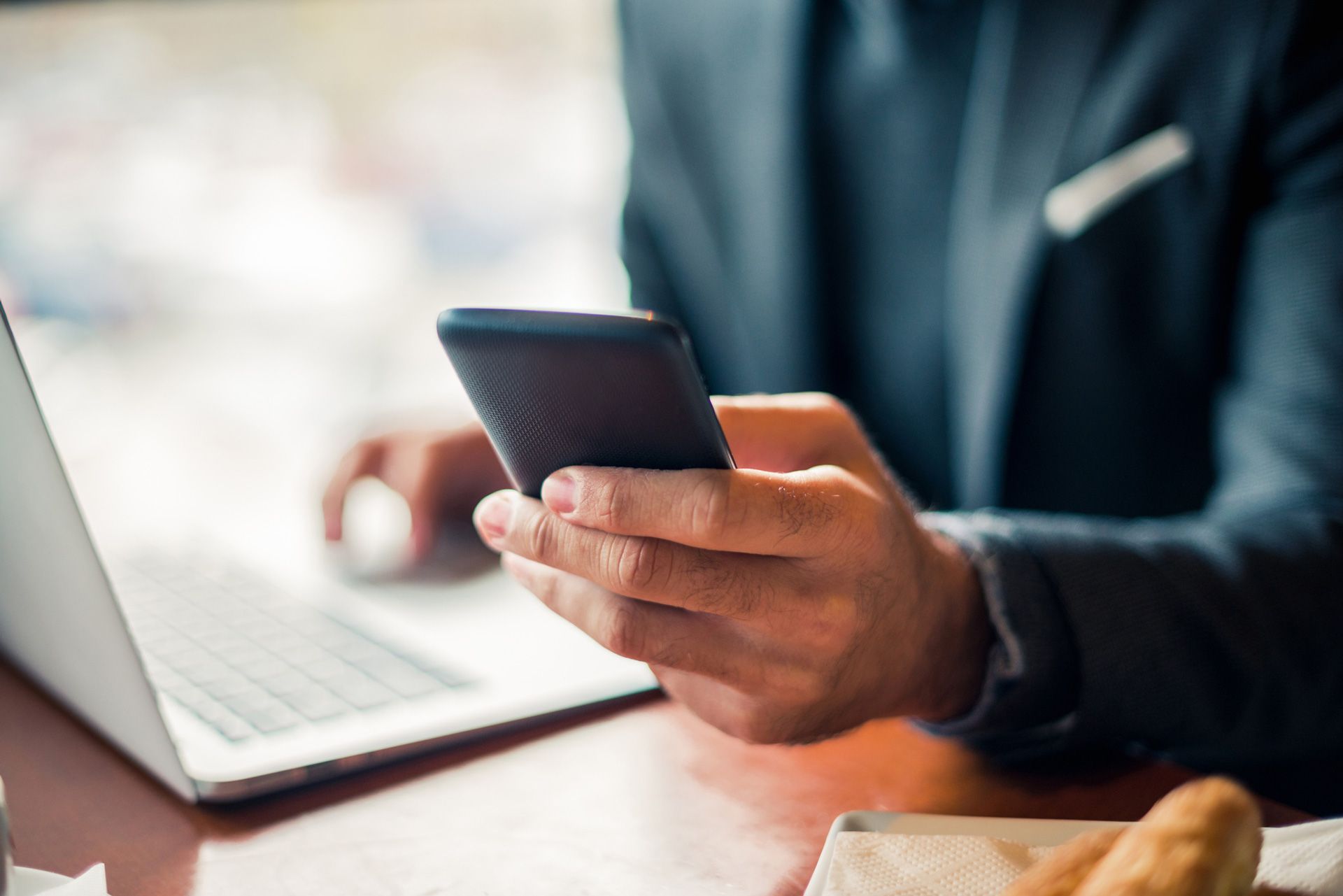 Man Looking At The Phone — South Burlington, VT — Superior Communications Inc