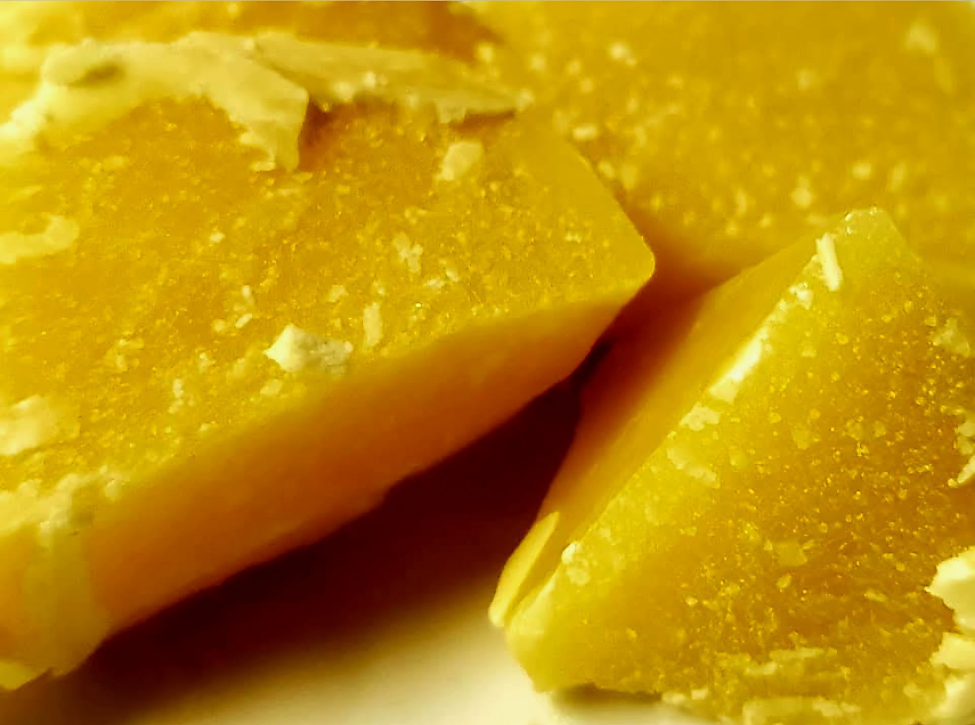 Close-up of yellow beeswax chunks.