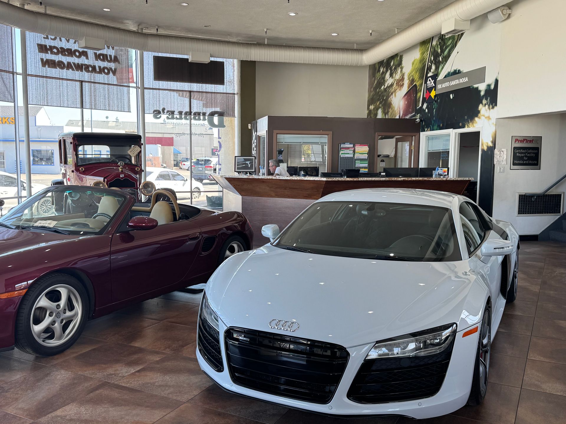 Silver Porsche in a garage, man opening door. | Dibble's Auto Center