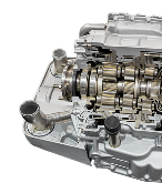Cutaway view of a gray car transmission showing gears, shafts, and other internal components - Dibble's Auto Center