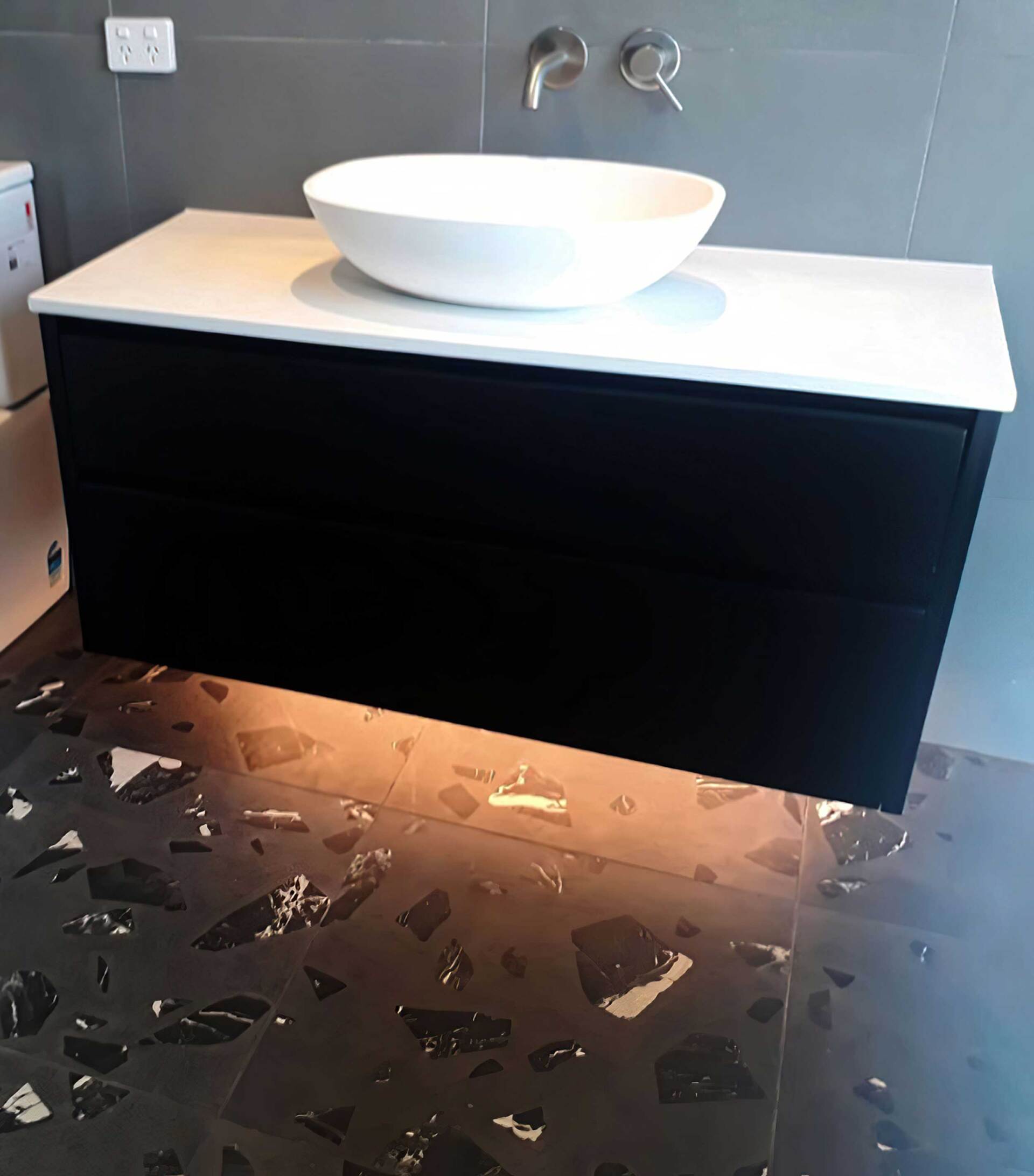 A bathroom vanity with a sink on top of it. Auckland Tilers