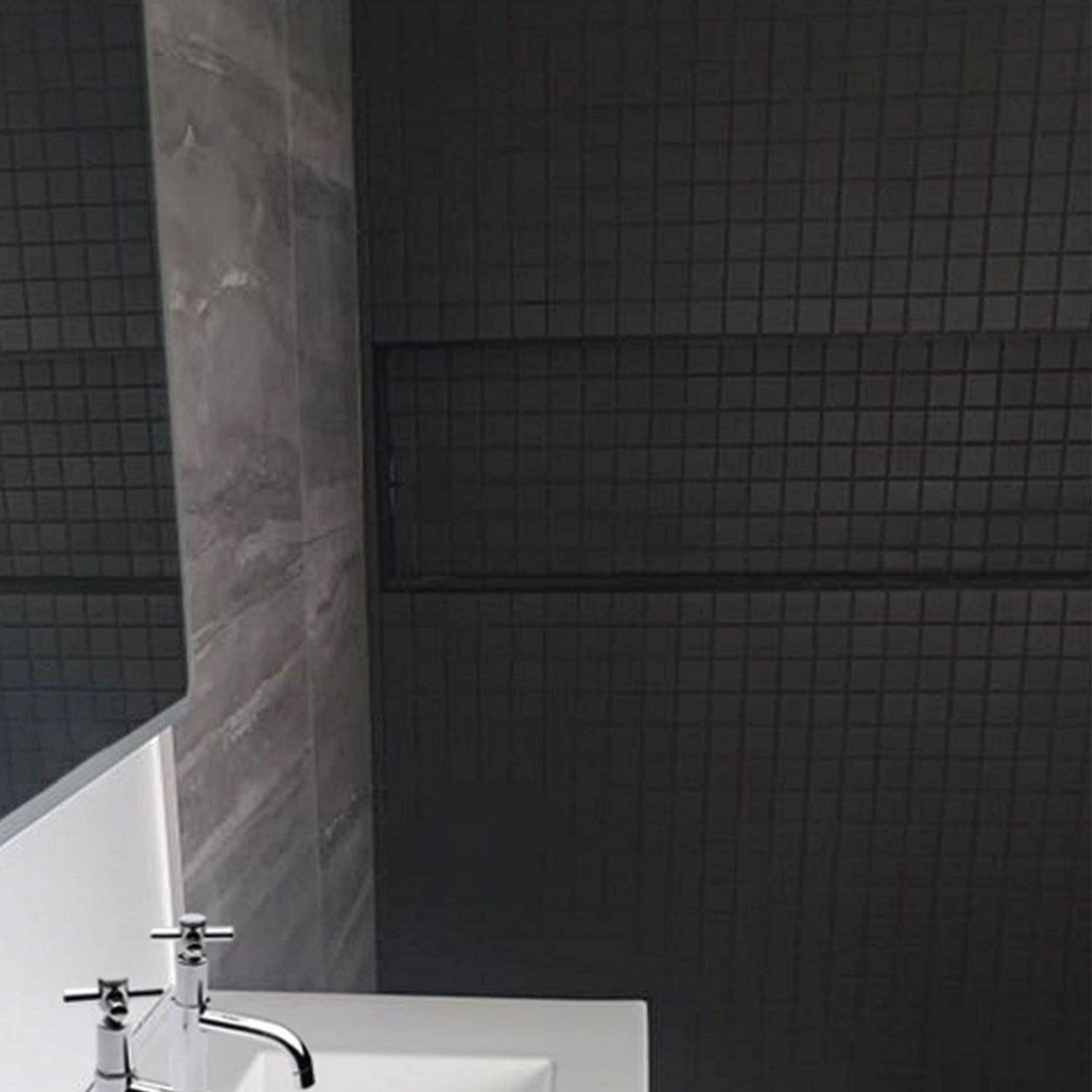 A bathroom with a sink , mirror , and black tiles. Auckland Tilers