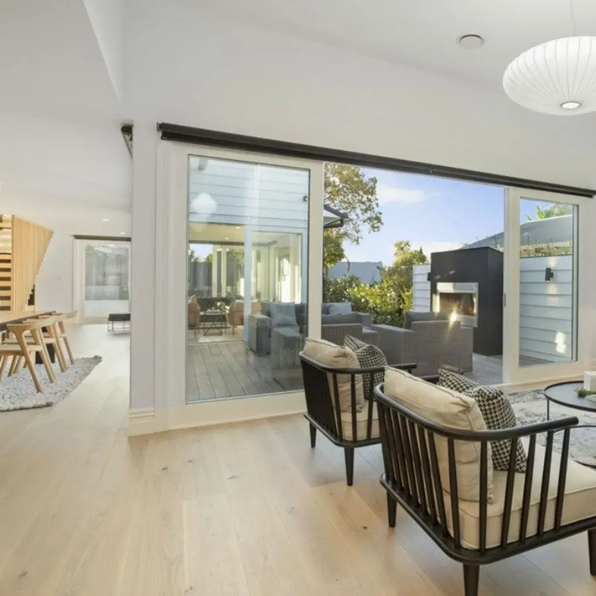 A living room with a lot of windows and chairs. Auckland Tilers